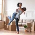 Happy couple first time home buyers celebrate moving day