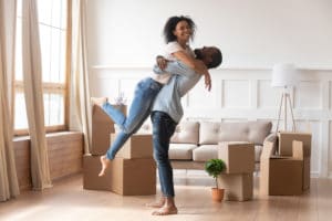 Happy couple first time home buyers celebrate moving day