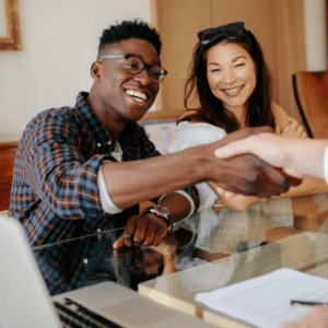 Young couple shaking hands with loan officer
